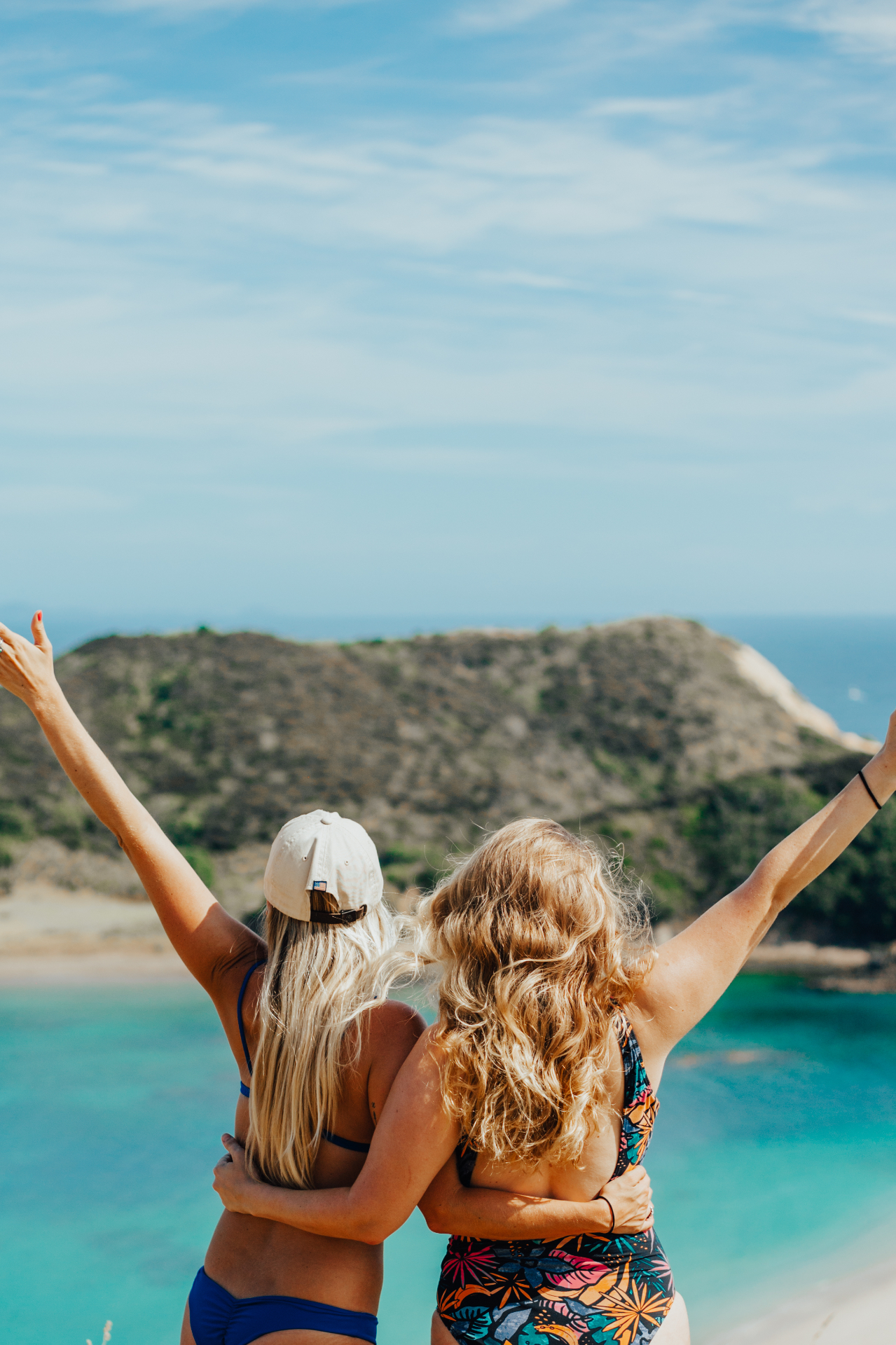 Friends celebrating an island viewpoint in the Bay of Islands